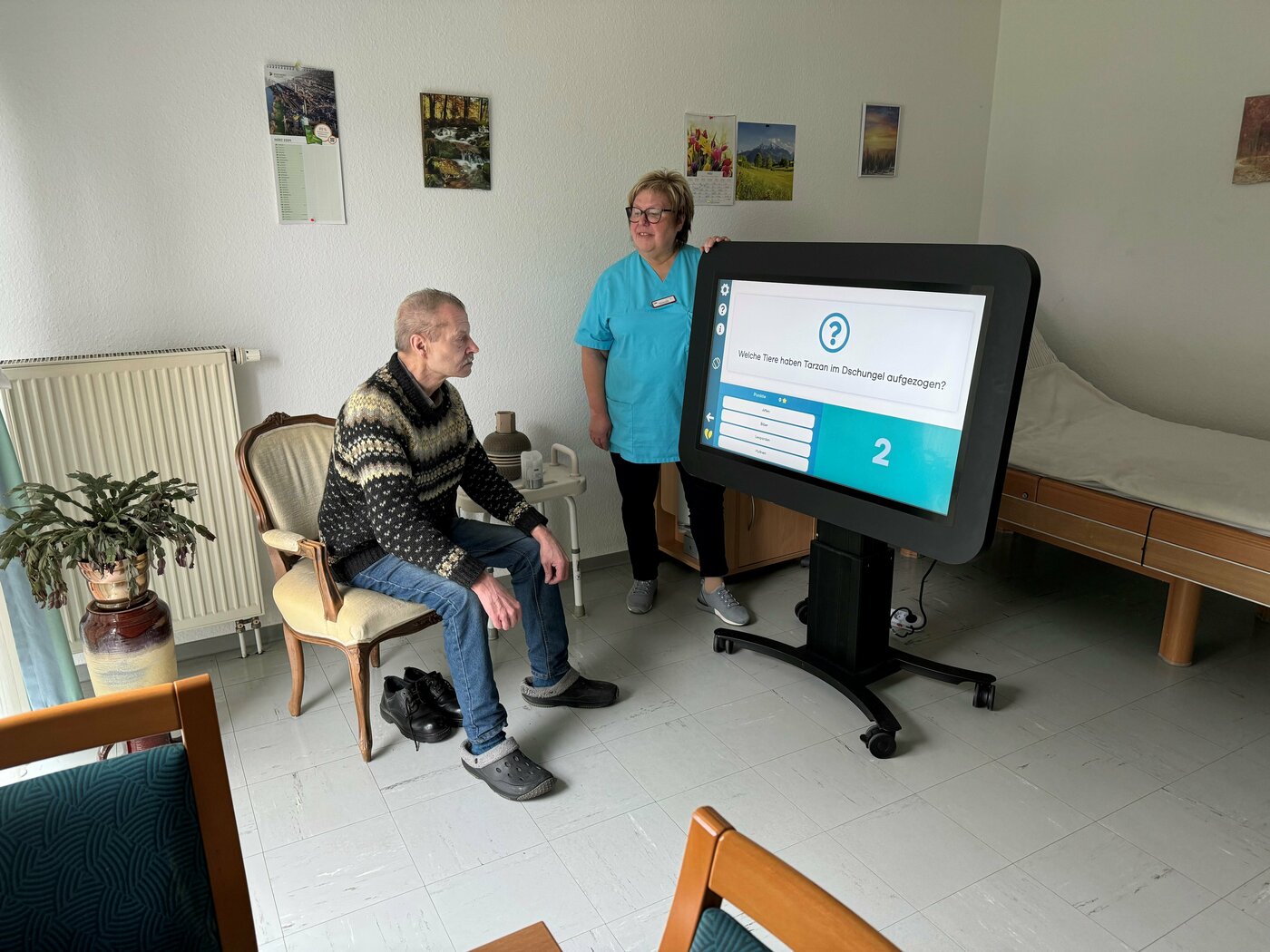 Das Foto zeigt einen Bewohner unserer Einrichtung mit einer Mitarbeiterin am Care-Table